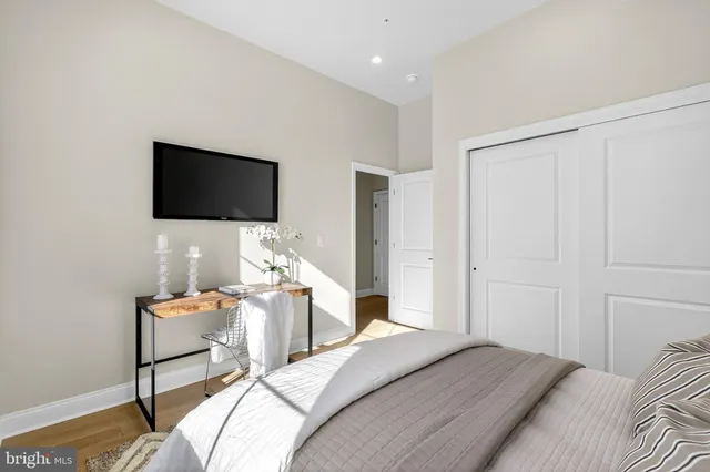 a bedroom with a bed and a painting on the wall