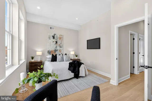 a bathroom with a granite countertop sink a toilet and shower