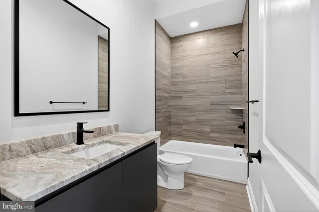 a hallway with stairs and wooden floor