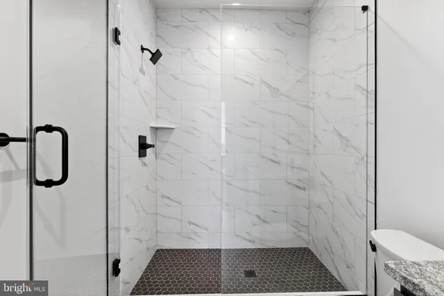 a bathroom with a double vanity sink toilet and mirror