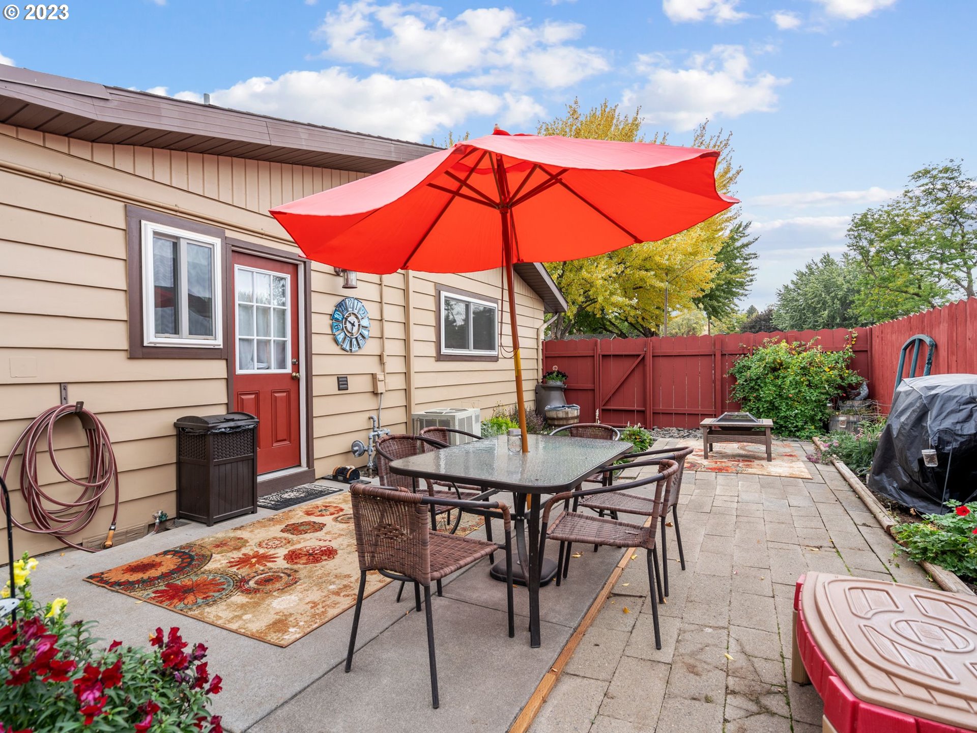 1341 Southwest 40th Street Pendleton, OR 97801 - Photo 6 of 35 a patio with a table and chairs under an umbrella