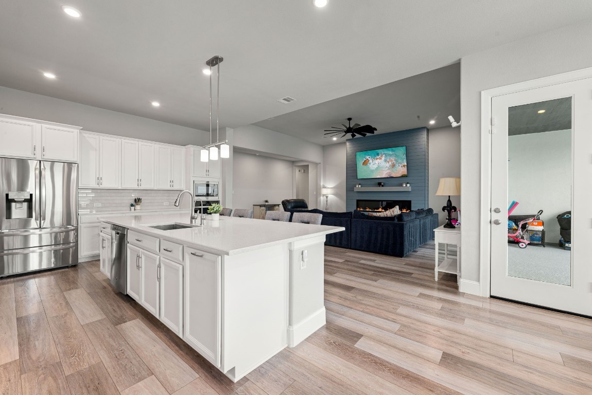 6203 Silver Lk Lane Manvel, TX 77578 - Photo 15 of 50 a large kitchen with stainless steel appliances lots of counter space and wooden floor