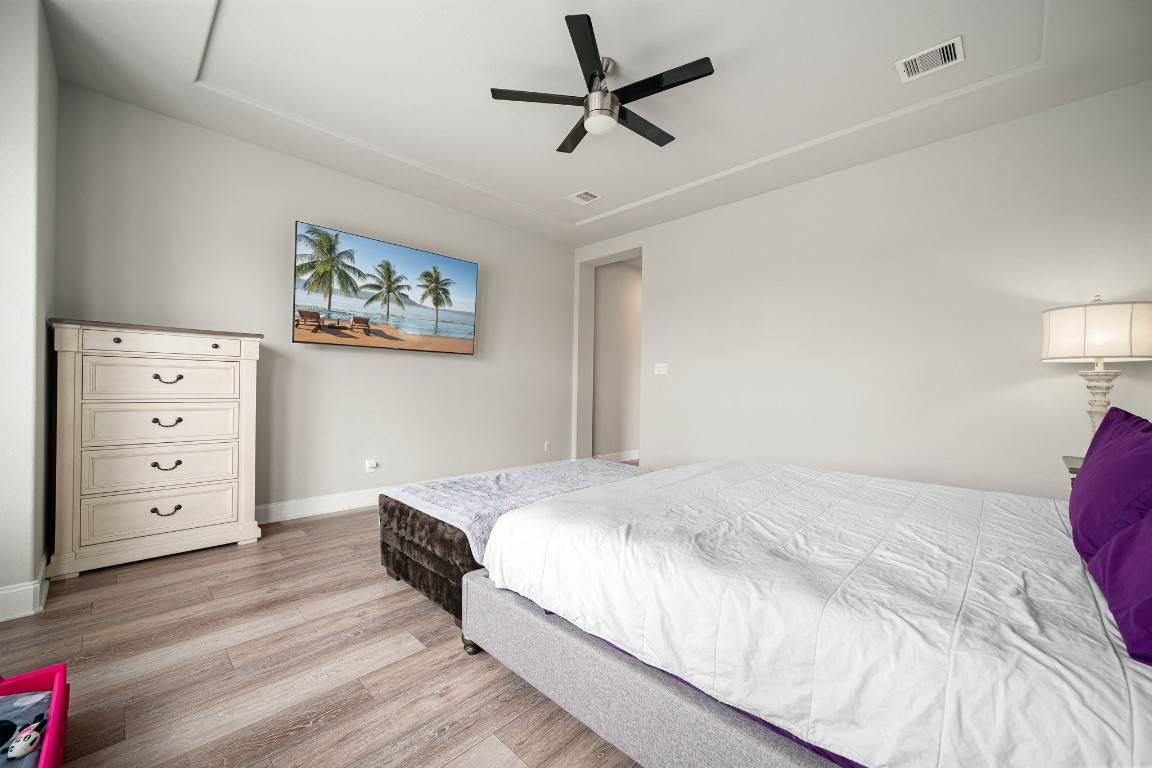 6203 Silver Lk Lane Manvel, TX 77578 - Photo 17 of 50 a bedroom with a bed and a chandelier