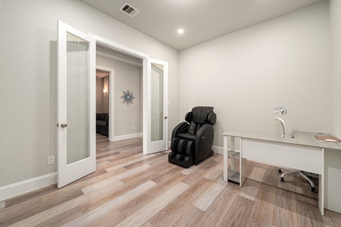 6203 Silver Lk Lane Manvel, TX 77578 - Photo 21 of 50 a view of a workspace with furniture and wooden floor