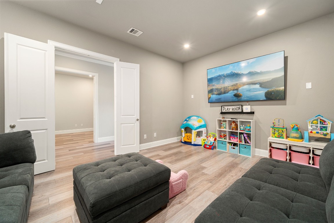 6203 Silver Lk Lane Manvel, TX 77578 - Photo 24 of 50 a living room with furniture and a flat screen tv