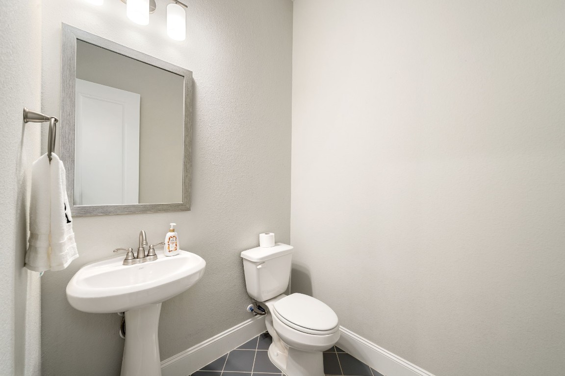 6203 Silver Lk Lane Manvel, TX 77578 - Photo 25 of 50 a bathroom with a sink a toilet and mirror