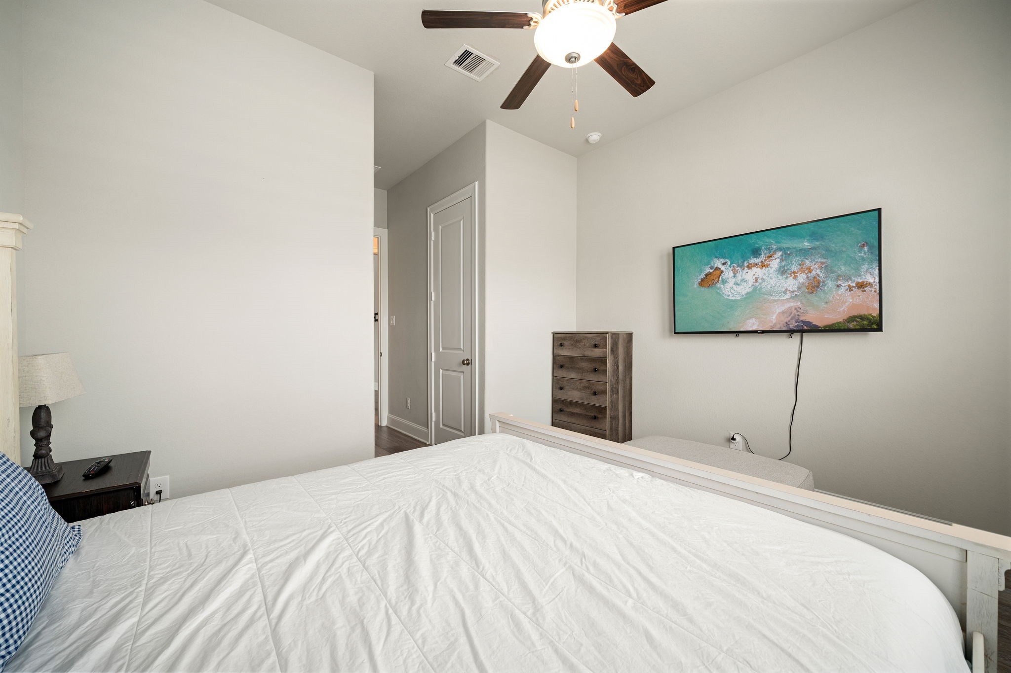 6203 Silver Lk Lane Manvel, TX 77578 - Photo 27 of 50 a bedroom with a large bed and a chandelier