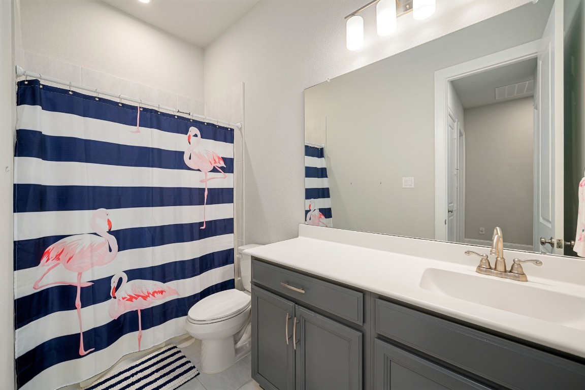6203 Silver Lk Lane Manvel, TX 77578 - Photo 28 of 50 a bathroom with a sink a toilet a shower and a mirror