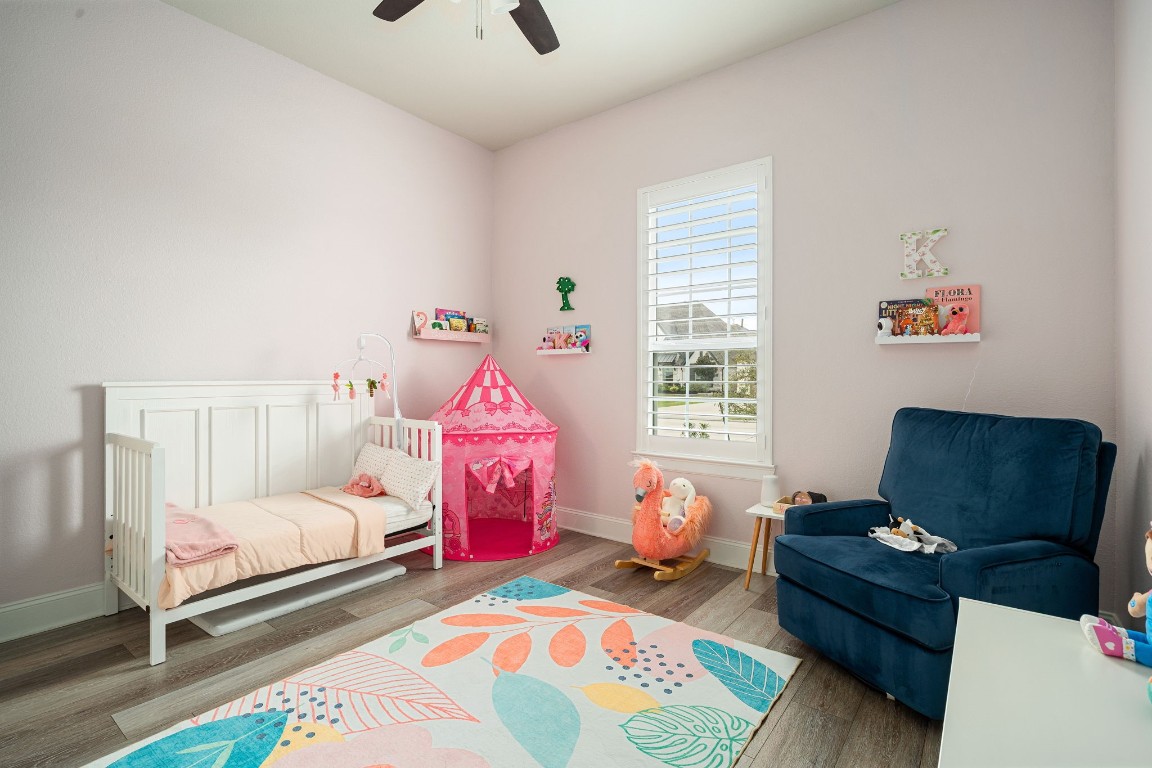 6203 Silver Lk Lane Manvel, TX 77578 - Photo 29 of 50 a bedroom with a bed and wooden floor