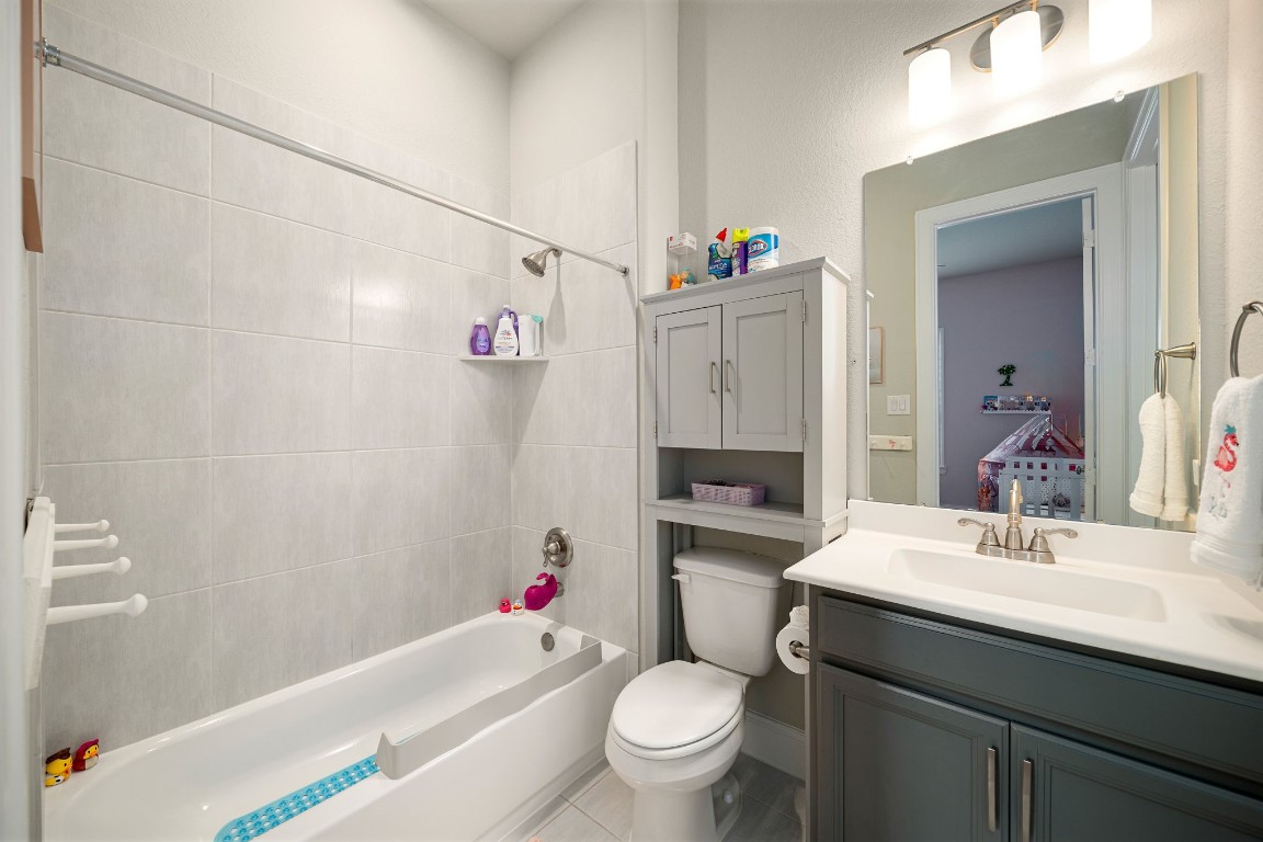 6203 Silver Lk Lane Manvel, TX 77578 - Photo 31 of 50 a bathroom with a sink toilet vanity and tub