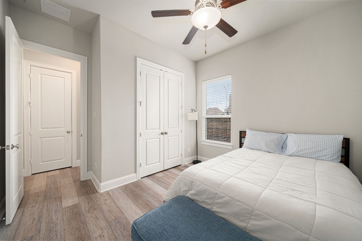 6203 Silver Lk Lane Manvel, TX 77578 - Photo 33 of 50 a bedroom with a large bed and a chandelier