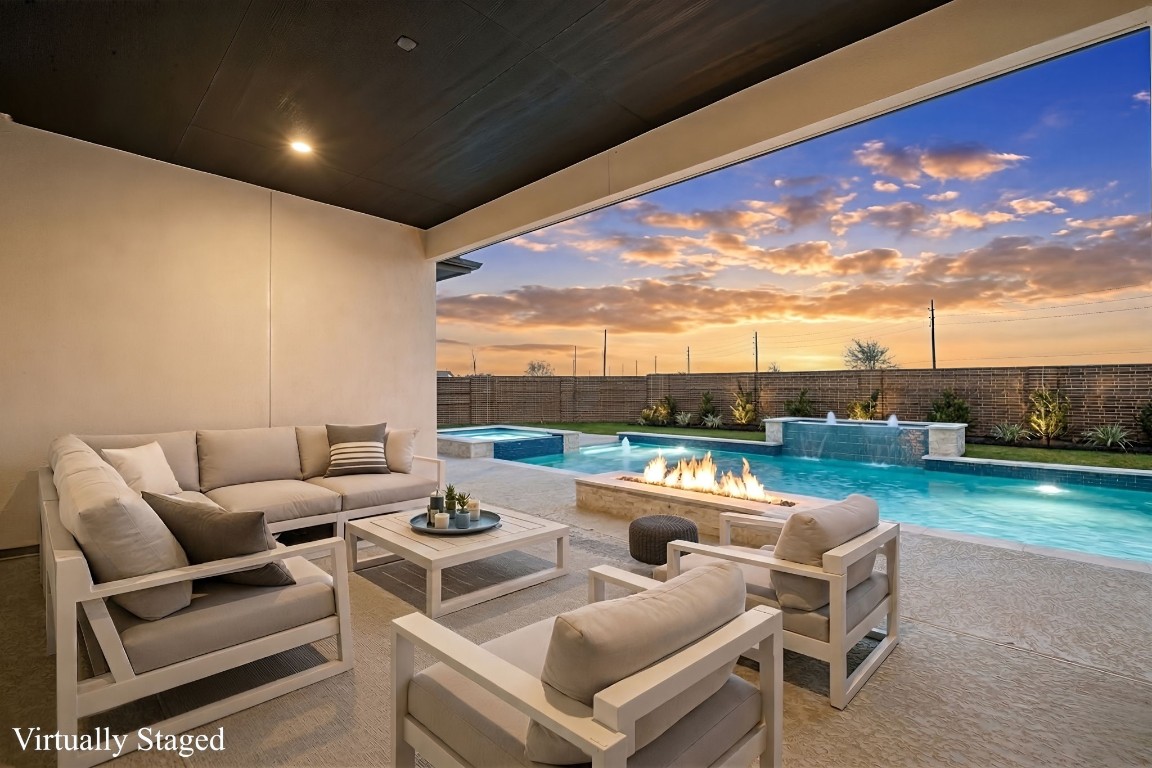 6203 Silver Lk Lane Manvel, TX 77578 - Photo 37 of 50 a roof deck with a table and chairs with swimming pool and outdoor seating