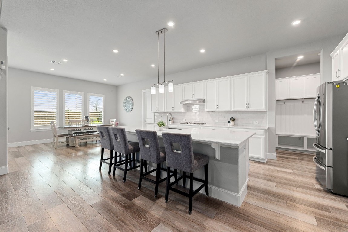 6203 Silver Lk Lane Manvel, TX 77578 - Photo 9 of 50 a large kitchen with a table and chairs