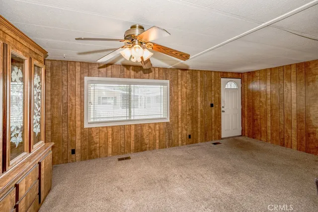 an empty room with windows and cabinet