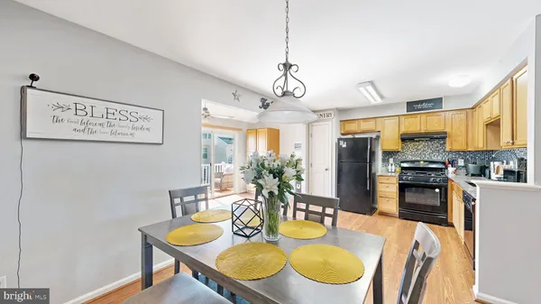 a dining room with furniture a window and kitchen view