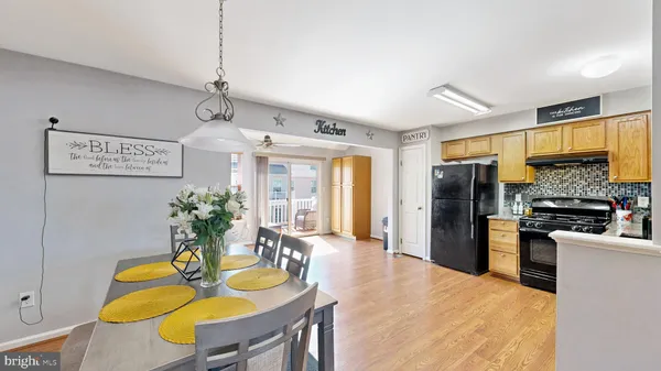 a kitchen with sink refrigerator dining table and chairs