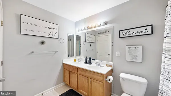 a bathroom with a sink mirror vanity and toilet