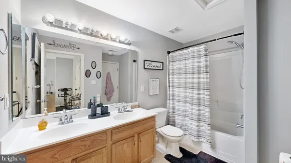 a bathroom with a sink vanity mirror and toilet