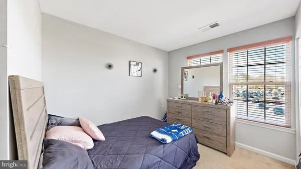 a bedroom with furniture and a large window