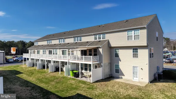 a view of a house with a yard balcony and sitting area
