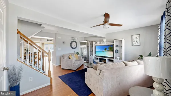 a living room with furniture wooden floor and a flat screen tv