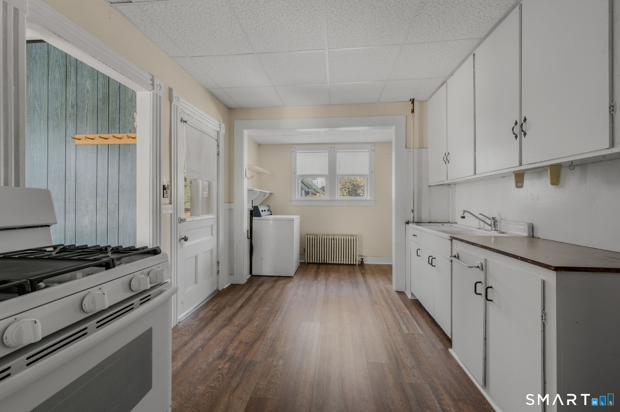 45 Dunham Street Norwich, CT 06360 - Photo 13 of 40 a kitchen with sink cabinets and wooden floor