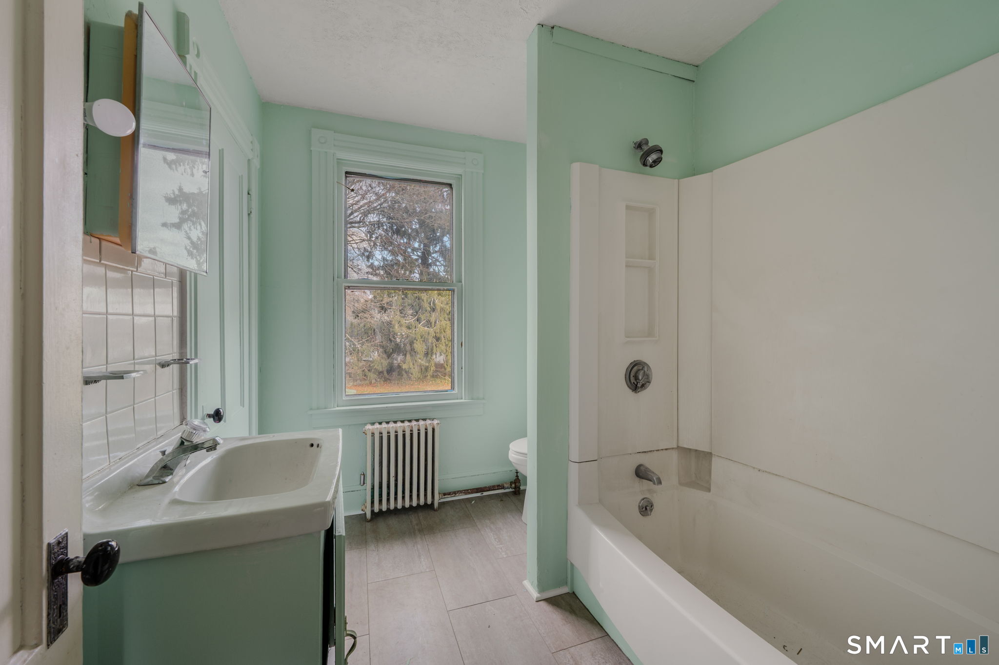 45 Dunham Street Norwich, CT 06360 - Photo 16 of 40 a bathroom with a tub sink and mirror