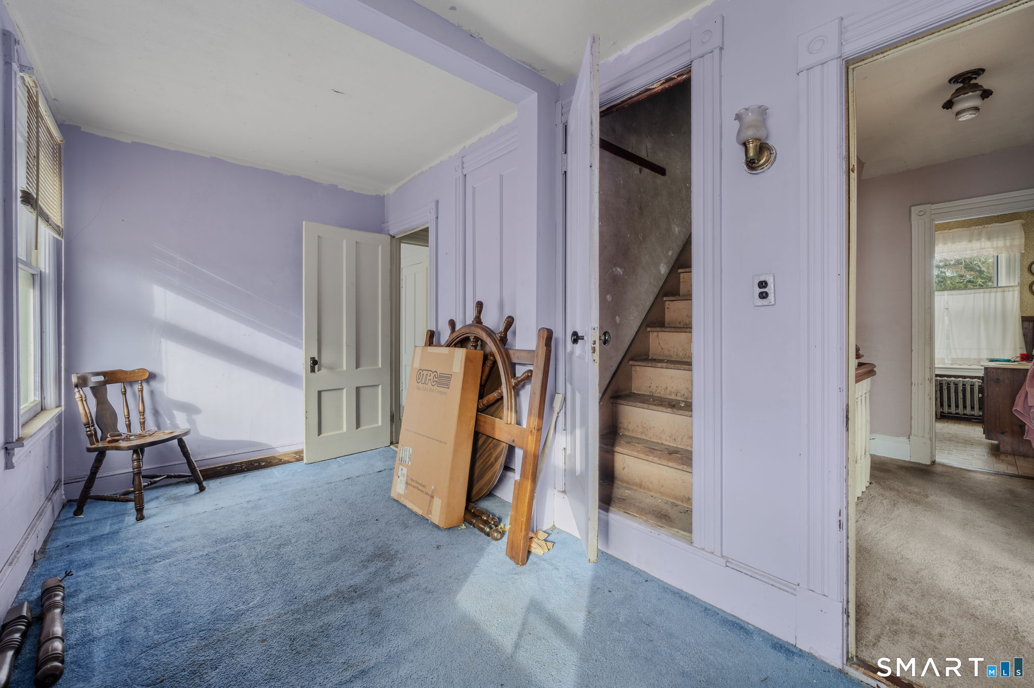 45 Dunham Street Norwich, CT 06360 - Photo 22 of 40 a view of a livingroom with stairs and furniture