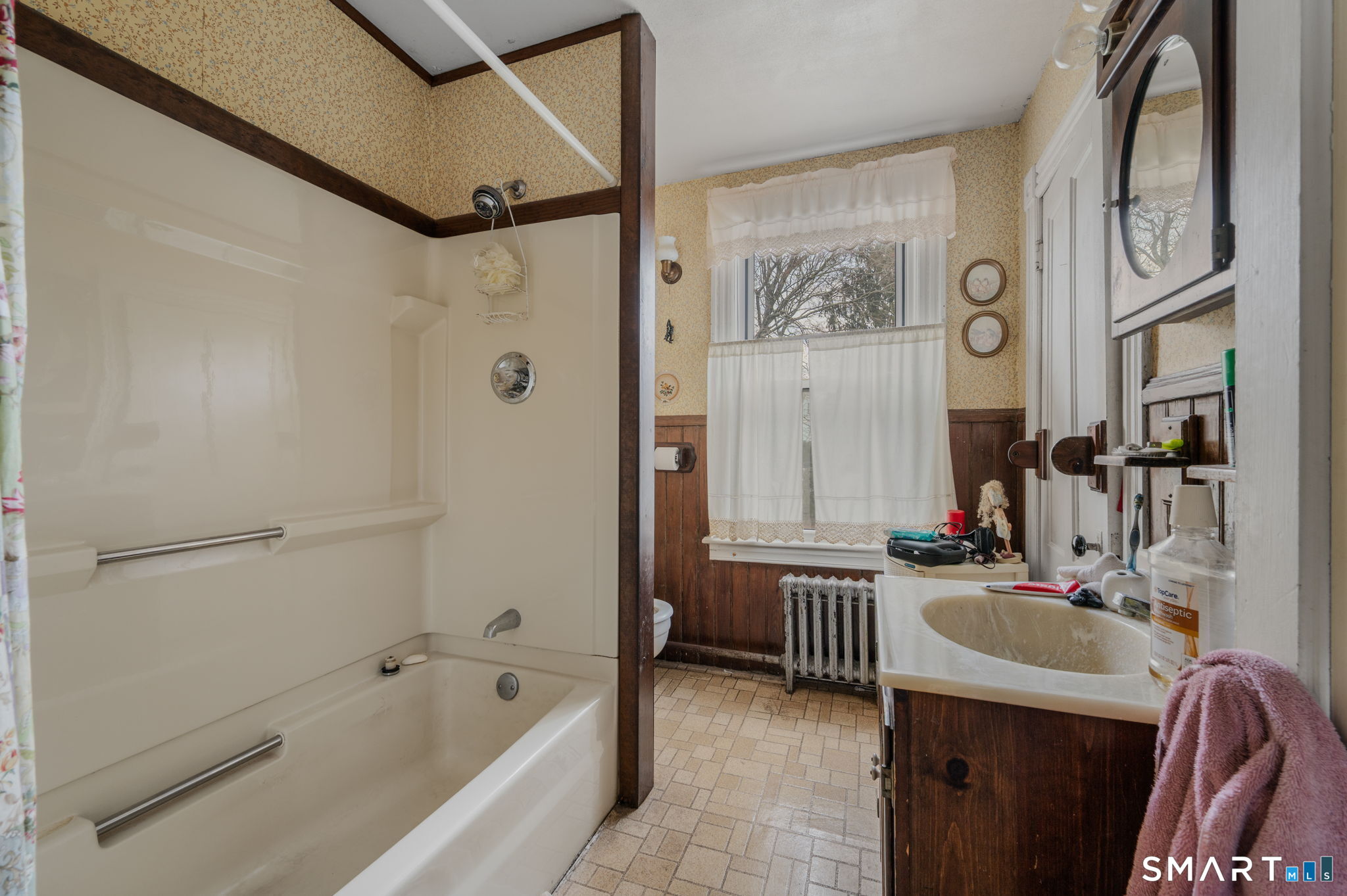 45 Dunham Street Norwich, CT 06360 - Photo 29 of 40 a bathroom with a tub sink and mirror