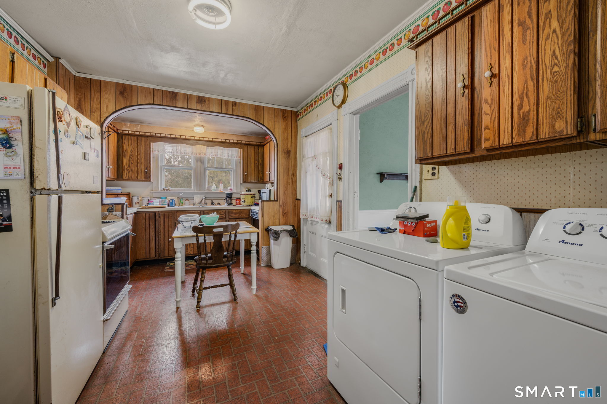 45 Dunham Street Norwich, CT 06360 - Photo 35 of 40 a kitchen with stainless steel appliances a stove a refrigerator and a dining table with wooden cabinet