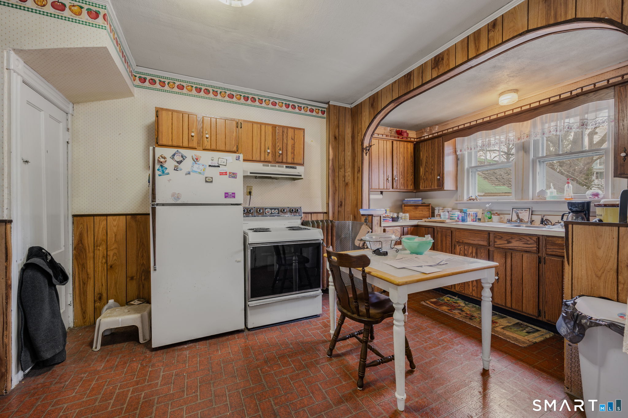 45 Dunham Street Norwich, CT 06360 - Photo 36 of 40 a kitchen with stainless steel appliances a stove a refrigerator a dining table and chairs