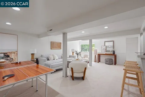 a living room with furniture a table and a fireplace
