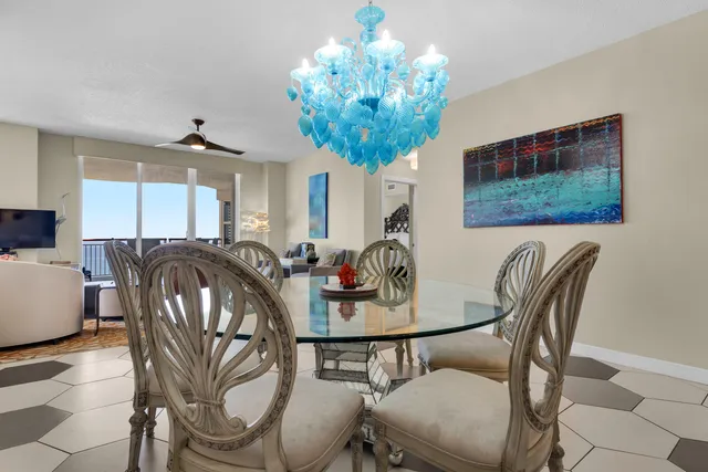 a view of a dining room with furniture and chandelier