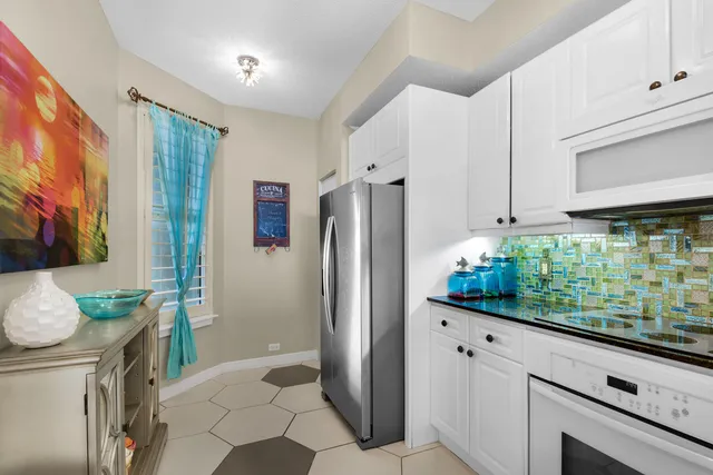 a kitchen with white cabinets