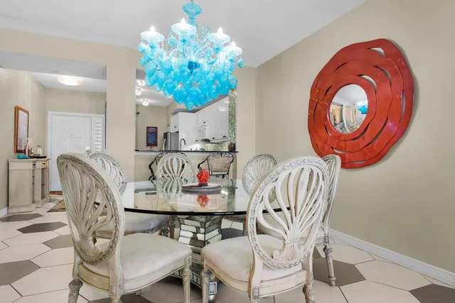 a dining room with furniture and chandelier
