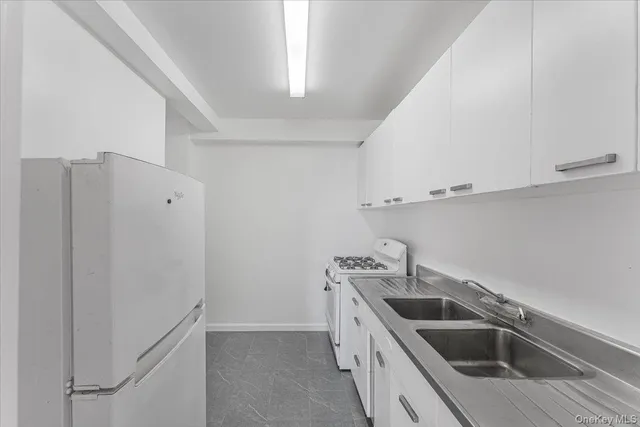 a kitchen with a sink and refrigerator