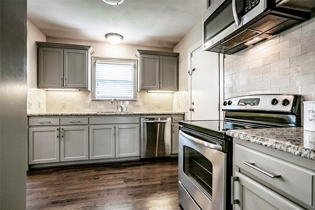 7410 Caillet Street Dallas, TX 75209 - Photo 11 of 25 a kitchen with stainless steel appliances granite countertop a sink and a stove
