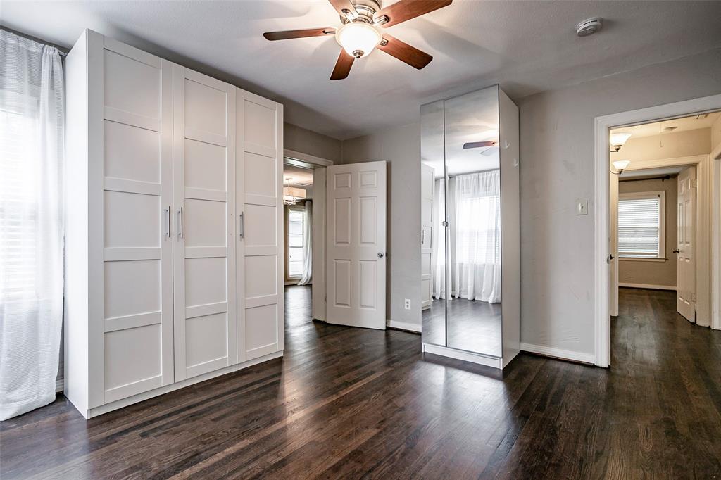 7410 Caillet Street Dallas, TX 75209 - Photo 12 of 25 an empty room with wooden floor and a ceiling fan