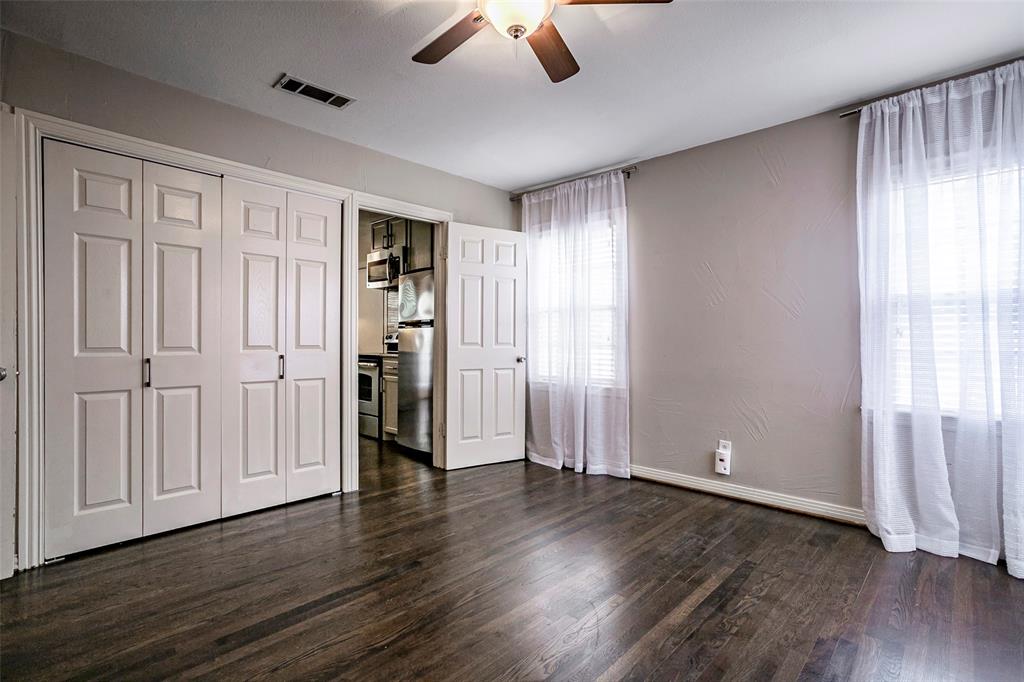7410 Caillet Street Dallas, TX 75209 - Photo 14 of 25 an empty room with wooden floor cabinet and windows