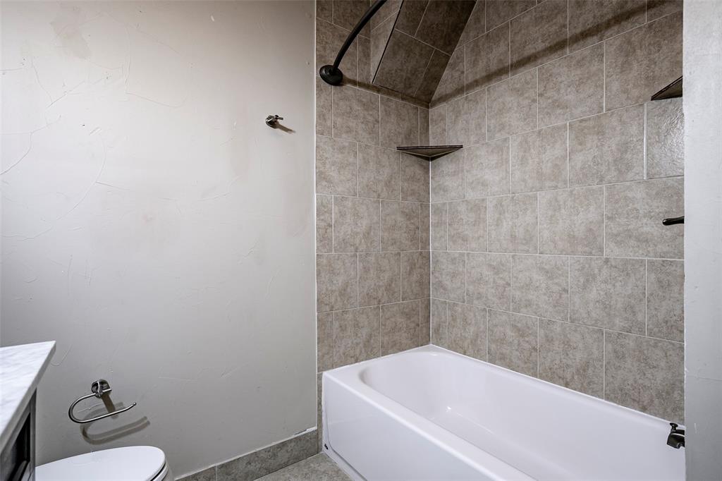 7410 Caillet Street Dallas, TX 75209 - Photo 19 of 25 a white bath tub sitting next to a toilet