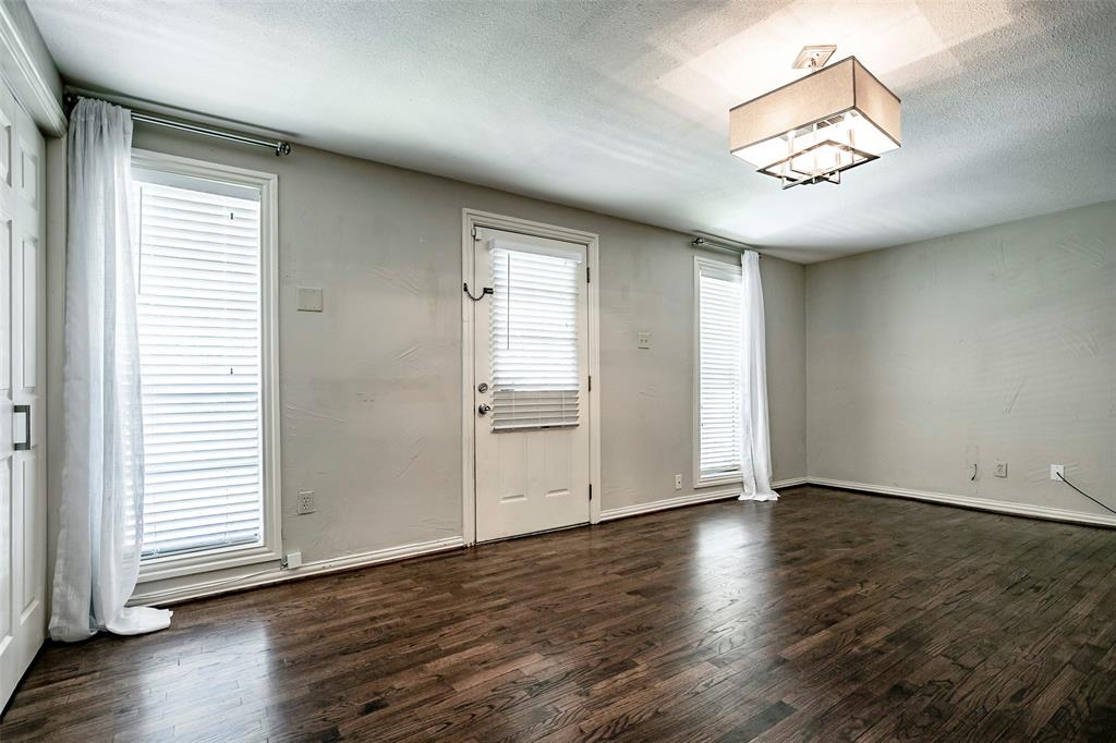 7410 Caillet Street Dallas, TX 75209 - Photo 21 of 25 an empty room with wooden floor and windows