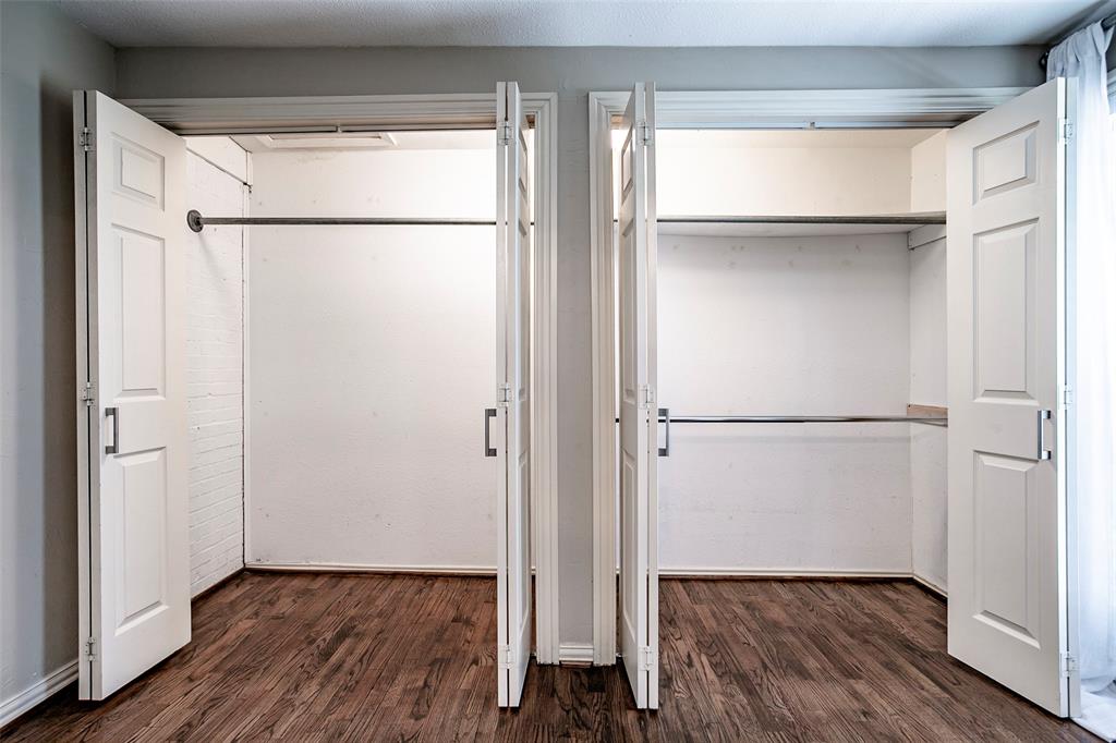 7410 Caillet Street Dallas, TX 75209 - Photo 22 of 25 a view of walk in closet with wooden floor