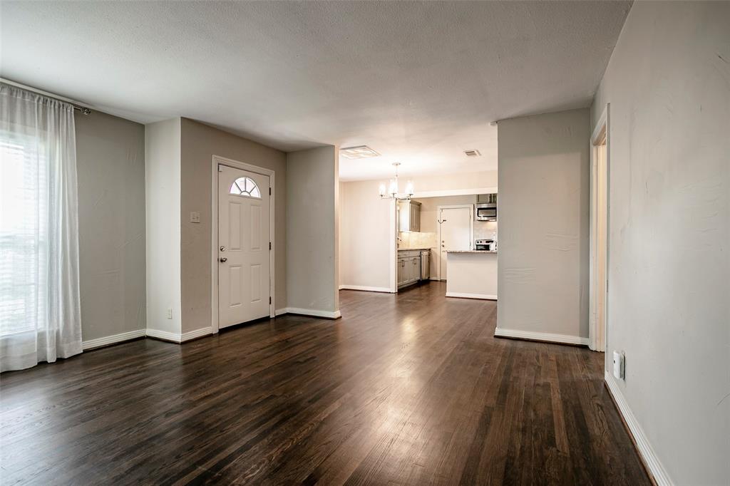 7410 Caillet Street Dallas, TX 75209 - Photo 6 of 25 an empty room with wooden floor and windows