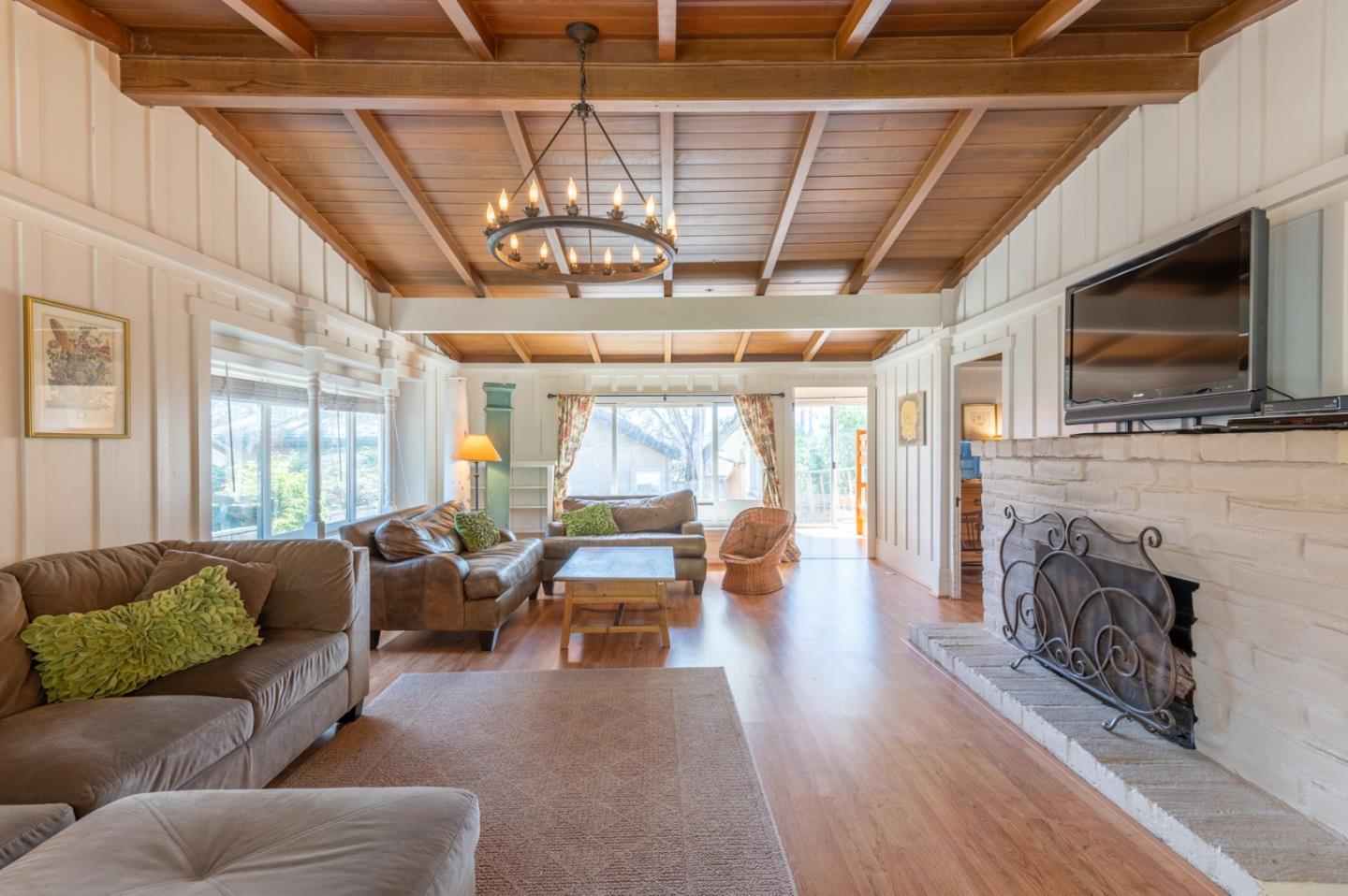 a living room with furniture a flat screen tv and a fireplace