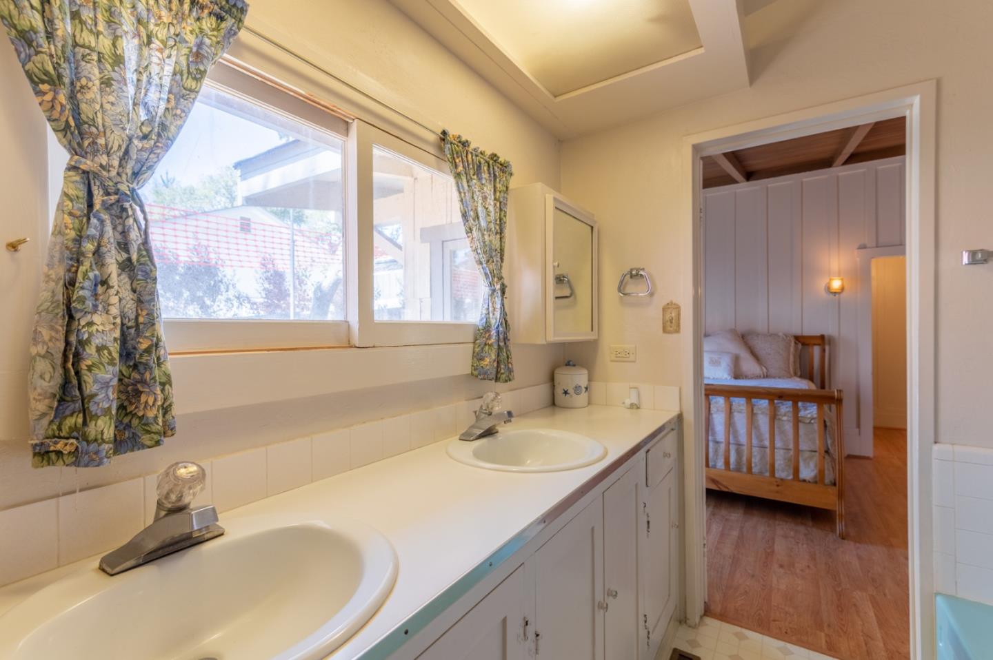2 Mission Street Carmel, CA 93923 - Photo 15 of 31 a bathroom with a sink and a mirror