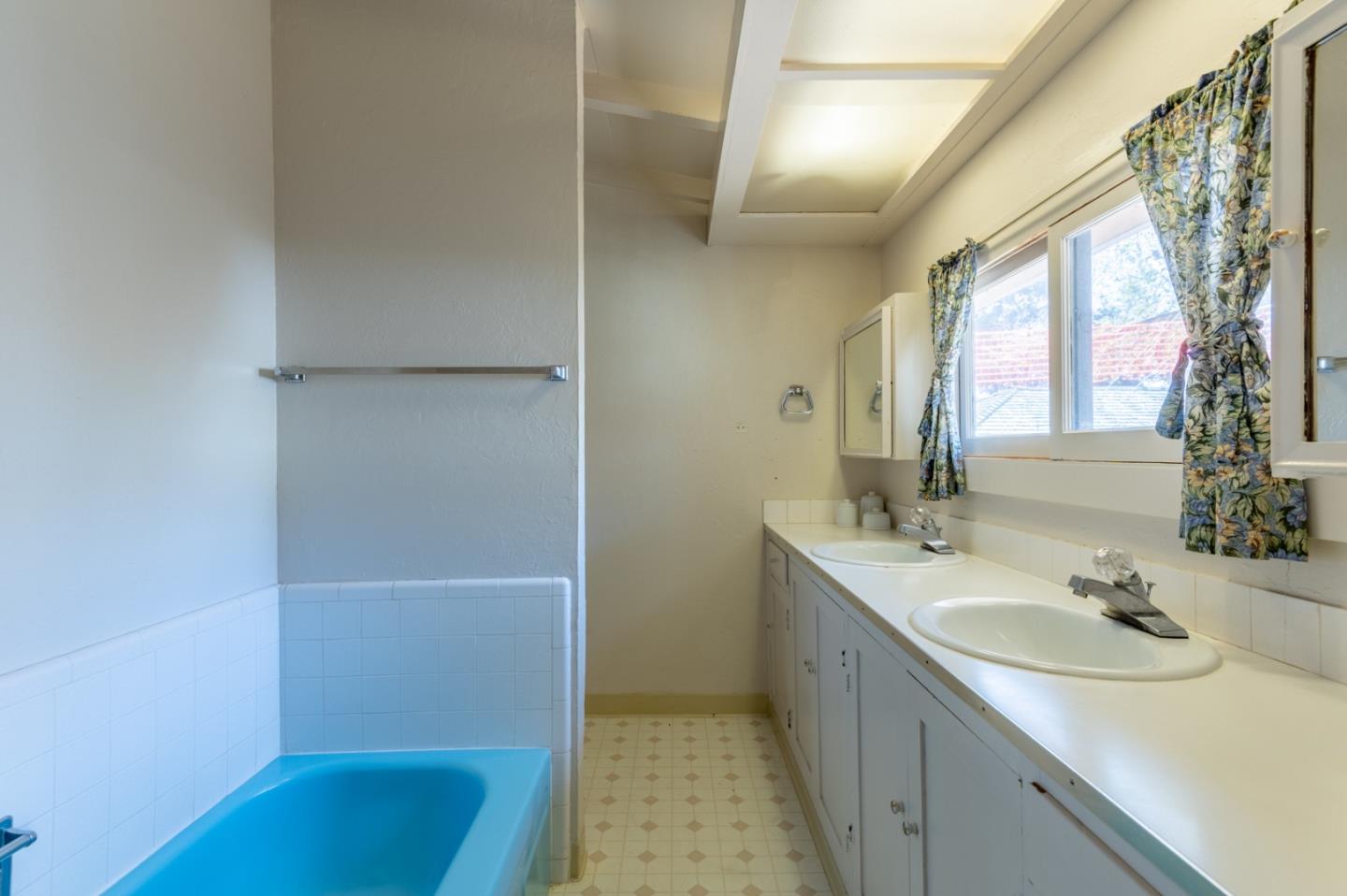 2 Mission Street Carmel, CA 93923 - Photo 17 of 31 a bathroom with a sink and a mirror