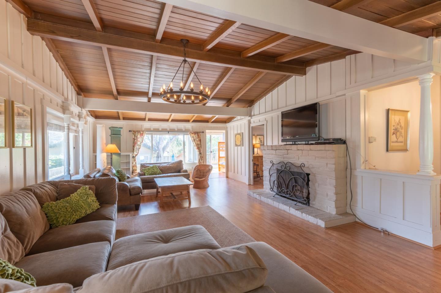 2 Mission Street Carmel, CA 93923 - Photo 2 of 31 a living room with furniture a fireplace and a flat screen tv