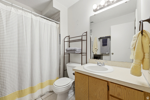 1175 Canyon Road, Unit 86 Ogden, UT 84404 - Photo 20 of 29 Bathroom featuring a built-in vanity with a white oval sink, light wood-finish cabinetry, and a full-width mirror with a three-bulb light fixture