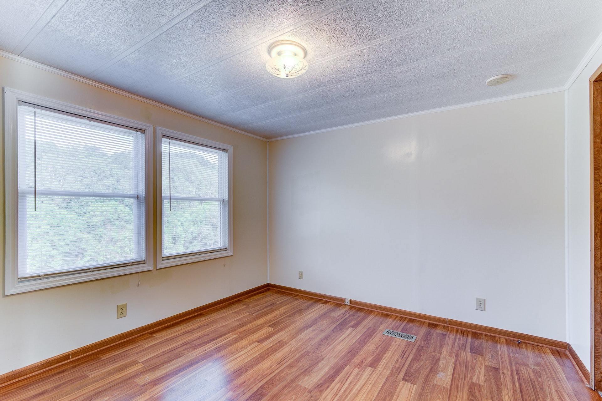 1103 Milton Road Blue Ridge, VA 24064 - Photo 15 of 29 an empty room with wooden floor and windows