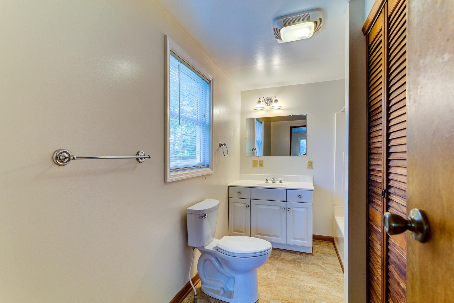 1103 Milton Road Blue Ridge, VA 24064 - Photo 17 of 29 a bathroom with a toilet sink and mirror
